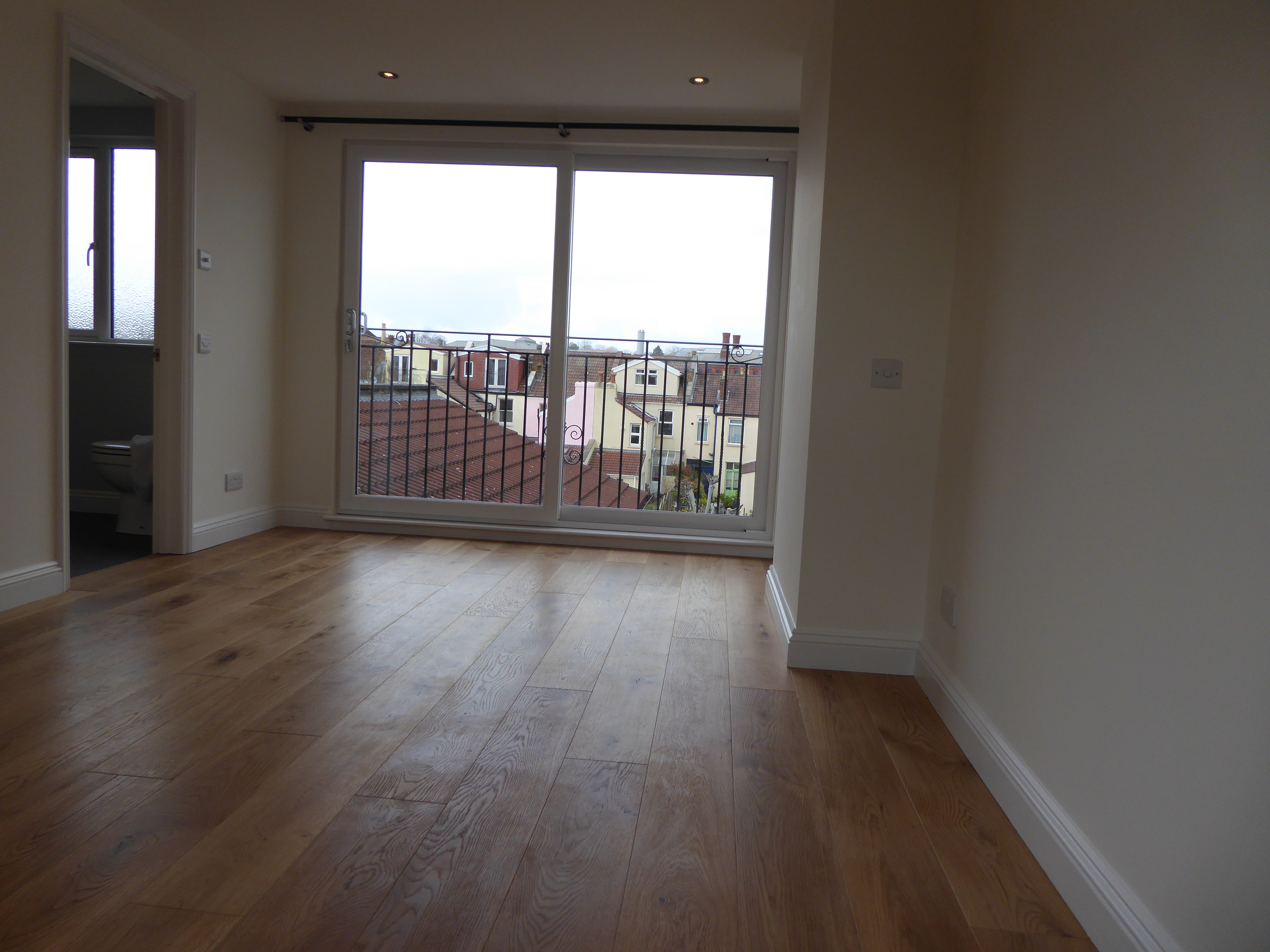 Masterbedroom with wood flooring